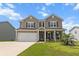 Charming two-story home with a well-manicured lawn and a two-car garage in a sunny neighborhood at 470 Sanctuary Park Dr, Summerville, SC 29486