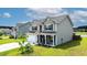Charming two-story home with a well-manicured lawn and inviting front porch at 470 Sanctuary Park Dr, Summerville, SC 29486