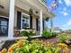 Inviting front porch with a sitting area, colorful flowers, and a South Carolina state flag at 470 Sanctuary Park Dr, Summerville, SC 29486