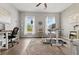 Open office space with a ceiling fan, patterned rug and two large windows at 470 Sanctuary Park Dr, Summerville, SC 29486