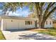 Exterior of home featuring white brick, attached garage, and driveway at 5259 Hartford Cir, North Charleston, SC 29405