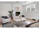 Cozy living room with a whitewashed fireplace, stylish furniture, and a large window at 5259 Hartford Cir, North Charleston, SC 29405