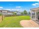 Large, grassy backyard with a screened patio area, play set, and wooden fence at 531 Crossland Dr, Moncks Corner, SC 29461