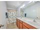 Bathroom features double sink vanity, tile floors, toilet, and a shower with a colorful curtain at 531 Crossland Dr, Moncks Corner, SC 29461