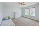 Bedroom with neutral carpet, white walls, ceiling fan, and a window overlooking the neighborhood at 531 Crossland Dr, Moncks Corner, SC 29461