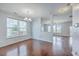 Open dining room with gleaming hardwood floors and modern lighting fixture at 531 Crossland Dr, Moncks Corner, SC 29461
