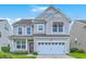 Charming two-story home with a well-manicured lawn and an attached two-car garage at 531 Crossland Dr, Moncks Corner, SC 29461
