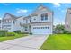 Charming two-story home with a well-maintained lawn and a two-car garage on a sunny day at 531 Crossland Dr, Moncks Corner, SC 29461