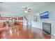 Open-concept living space featuring hardwood floors, modern lighting, and cozy fireplace at 531 Crossland Dr, Moncks Corner, SC 29461