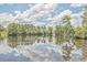 Scenic view of a tranquil pond surrounded by lush greenery and reflective clouds at 531 Crossland Dr, Moncks Corner, SC 29461