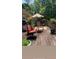 Cozy back deck with comfortable seating, shade umbrella and potted plants, perfect for relaxing outdoors at 5423 Buckeye Rd, Hollywood, SC 29449