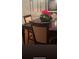 Close-up shot of dining room table with nice wood table and chair set, plus flower decorations at 5423 Buckeye Rd, Hollywood, SC 29449