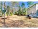 Large backyard with mature trees and a basketball hoop, perfect for outdoor activities at 62 Wexford Way, Walterboro, SC 29488