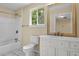 Neutral bathroom with white cabinets, tub and shower combination, and an ornate mirror at 62 Wexford Way, Walterboro, SC 29488