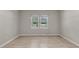 Light-filled bedroom with wood floors and views of the manicured front yard at 62 Wexford Way, Walterboro, SC 29488