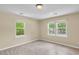 Cozy bedroom featuring two windows, neutral walls and updated flooring at 62 Wexford Way, Walterboro, SC 29488
