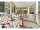 Relax on this spacious front porch featuring a swing and rocking chairs, perfect for outdoor living at 62 Wexford Way, Walterboro, SC 29488
