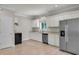 Well-lit kitchen boasts white cabinets, a stainless steel refrigerator, and a black oven for modern living at 62 Wexford Way, Walterboro, SC 29488