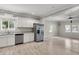 Modern kitchen with white cabinets, stainless steel appliances, and stylish gray countertops next to a dining area at 62 Wexford Way, Walterboro, SC 29488