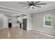 Open-concept living room with light wood floors and view into the modern white kitchen at 62 Wexford Way, Walterboro, SC 29488