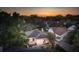 Sunset aerial view of the charming home with a fenced yard and outdoor dining space at 66 Darlington Ave, Charleston, SC 29403