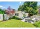 Home exterior featuring a backyard with chairs, foliage, and a small deck with stairs at 66 Darlington Ave, Charleston, SC 29403