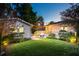 Cozy backyard illuminated with string lights, featuring a patio set and well-maintained lawn at 66 Darlington Ave, Charleston, SC 29403