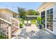 Outdoor patio with chairs, landscaping, string lights, and french doors on the exterior of the home at 66 Darlington Ave, Charleston, SC 29403