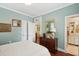 Airy bedroom featuring wood floors, light blue walls, and classic wood furnishings at 66 Darlington Ave, Charleston, SC 29403