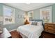 Serene bedroom with hardwood floors, natural light, and a comfortable bed with stylish decor at 66 Darlington Ave, Charleston, SC 29403