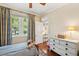Bedroom with hardwood floors, natural light, and a view of lush greenery at 66 Darlington Ave, Charleston, SC 29403