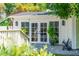 View of the exterior patio with french doors leading inside and a white railing to the left at 66 Darlington Ave, Charleston, SC 29403