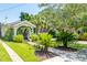 Charming home with a vine-covered porch, lush landscaping, and well-maintained front yard at 66 Darlington Ave, Charleston, SC 29403