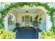 Welcoming front porch with an arched entryway, decorative plants, and a cozy seating area at 66 Darlington Ave, Charleston, SC 29403