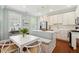 Bright kitchen featuring a white cabinets, modern stainless steel appliances, and an adjacent dining area at 66 Darlington Ave, Charleston, SC 29403