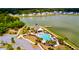 An aerial view of the community pool, clubhouse, and pier sitting on the lake at 6972 Pumpkinseed Dr, Johns Island, SC 29455
