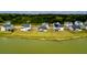 Scenic aerial view of waterfront homes with lush greenery and serene lake backdrop at 6972 Pumpkinseed Dr, Johns Island, SC 29455