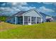 A spacious screened in porch sitting in a well-maintained, grassy backyard at 6972 Pumpkinseed Dr, Johns Island, SC 29455