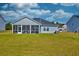 A spacious screened in porch sitting in a well-maintained, grassy backyard at 6972 Pumpkinseed Dr, Johns Island, SC 29455