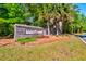 Brick signage for Saint Johns Lake community enhanced by palm trees and manicured flowerbeds at 6972 Pumpkinseed Dr, Johns Island, SC 29455