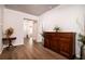 Entryway features wood floors, a large wooden cabinet, and a decorative round table at 6972 Pumpkinseed Dr, Johns Island, SC 29455