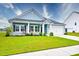 Charming single-story home featuring a well-manicured lawn, covered porch, and attached garage at 6972 Pumpkinseed Dr, Johns Island, SC 29455