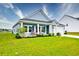 Well-kept single-story home with green lawn, inviting porch, and attached garage at 6972 Pumpkinseed Dr, Johns Island, SC 29455