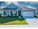 Inviting home exterior with a well-kept lawn and a welcoming front entrance at 6972 Pumpkinseed Dr, Johns Island, SC 29455