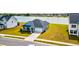 Aerial view of a charming blue two-story home with a two car garage and well manicured lawn in a Gathering friendly neighborhood at 6972 Pumpkinseed Dr, Johns Island, SC 29455