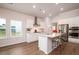 Modern kitchen with white cabinets, stainless steel appliances, and a spacious center island at 6972 Pumpkinseed Dr, Johns Island, SC 29455