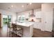 Bright kitchen with white cabinets, island with seating, and stainless steel appliances at 6972 Pumpkinseed Dr, Johns Island, SC 29455