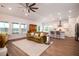 Open concept living room with a view of the kitchen, ample natural light and wood floors at 6972 Pumpkinseed Dr, Johns Island, SC 29455