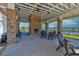 An outdoor brick fireplace under a covered pavilion with lake view at 6972 Pumpkinseed Dr, Johns Island, SC 29455