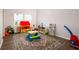 Spacious playroom with a colorful rug, playhouse, and various toys at 6972 Pumpkinseed Dr, Johns Island, SC 29455